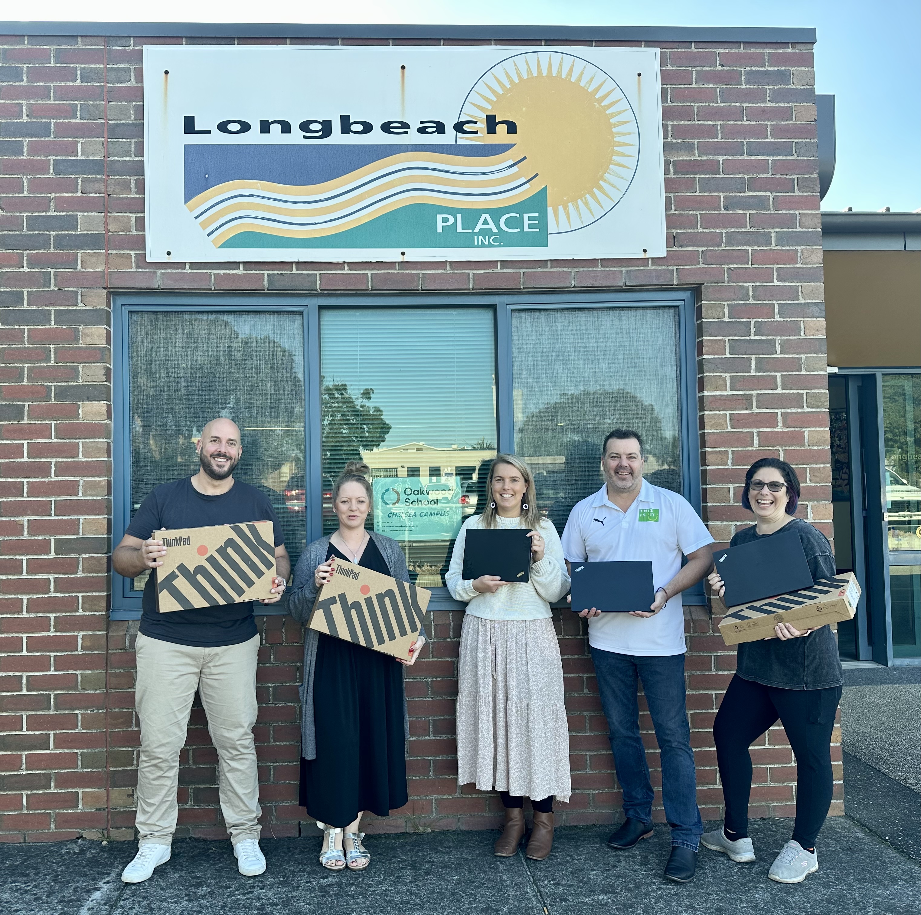 The This Is IT team delivering laptops to a community partner